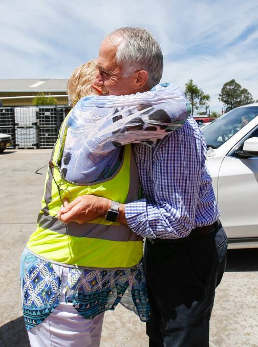 WARM WELCOME: Gilmore MP Ann Sudmalis embraces Prime Minister Malcom Turnbull during his visit to a Nowra chemical business on Friday. Pictures: Adam McLean