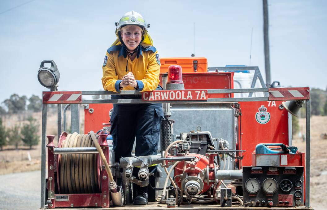 German au pair Jule Hansen, 20, on the back of the Carwoola fire truck. Her first day on the NSW fireground was on a catastrophic day. Pictures: Karleen Minney