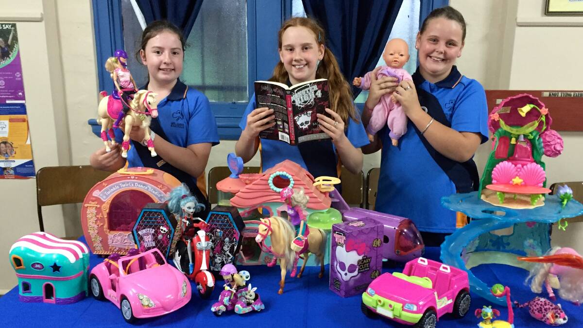 TREASURES: Nowra Girl Guides Gabby Levick, Violet Venn and Boudeeka James prepare for their garage sale on Sunday, July 3. The sale will raise money for the RSPCA Nowra Shelter. 