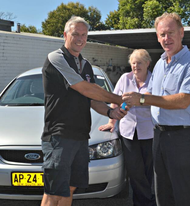 REVVED UP: Vickie and Gary Gilbert are one step closer to taking on the Shitbox Rally after receiving the keys to a car from Graig Solomon from Solomon Motor Group. 