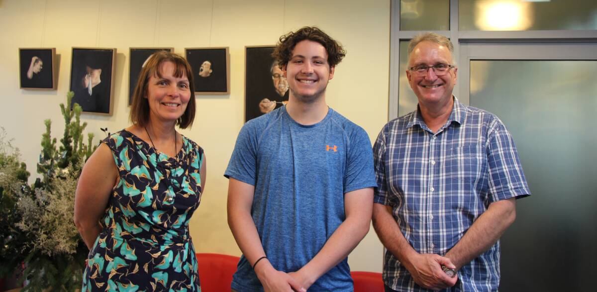 HARD WORK REWARDED: Lorrae Sampson, executive principal and Peter O’Donnell,  Director of Studies and English teacher congratulate Ethan Ford on his HSC results. 