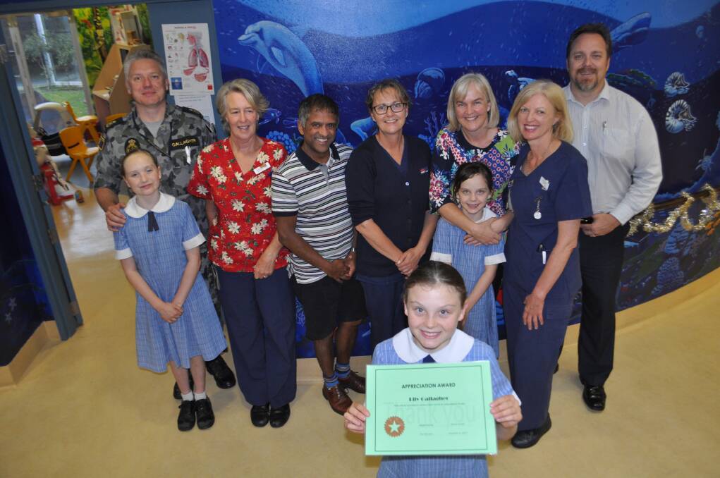 APPRECIATED: Lily Gallagher (front) with Madeline and Lee Gallagher, Karin Baldwin, Mark deSouza, Julie Mairinger, Laura and Agnes Gallagher, Karen Watson and Stuart Emslie. The 10-year-old donated her babysitting money to the Children's Ward.