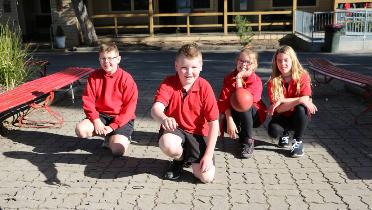 GAME, SET, MATCH: Hunter Woods. Mitch Clark, Charlize Watson and Holly Barrett ready to put their handball skills to the test. Photo: Nowra Hill Public School. 