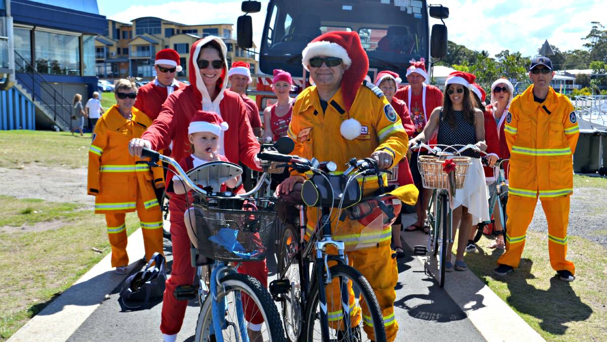 READY TO RIDE: Cassie Lawrence, little Mila Walsh and Huskisson Fire Brigade captain Joey Revesz lead the troops in a practise Santa Ride ahead of the Thursday, December 15 event.