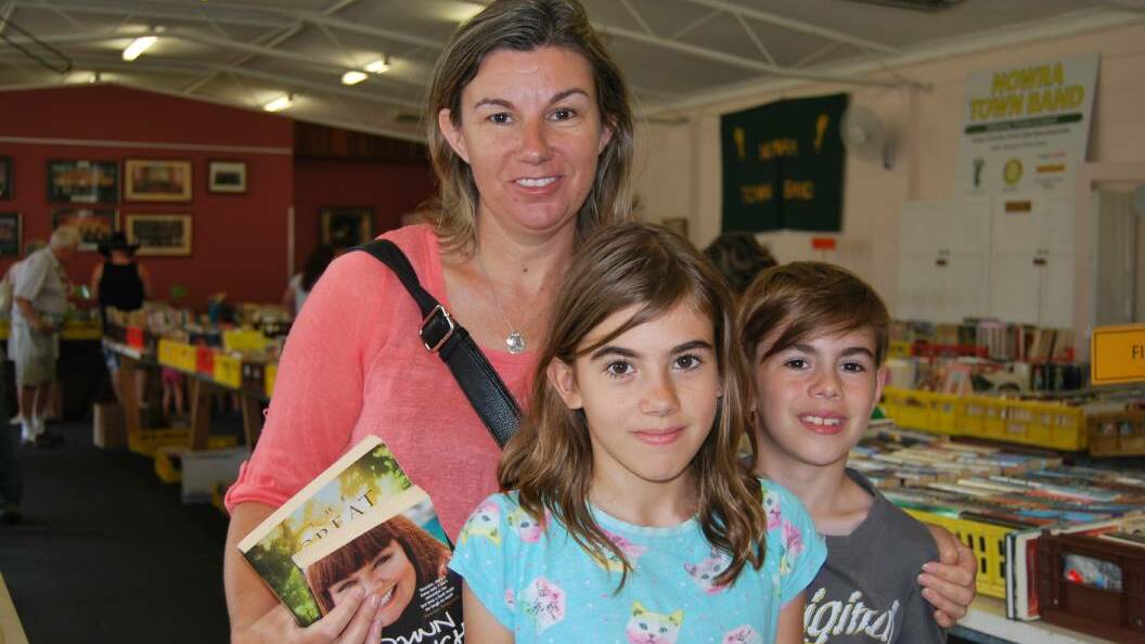 PAGE TURNER: Jenny, Caitlin and Aiden Schaefer at last year's Nowra Town Band Book Sale. The event will be held January 21 and January 22. 
