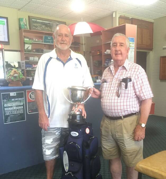 Nowra Golf Club's Denis Mulvihill, the winner of the Manildra Cup receiving the trophy from Brian Hanley from the Manildra Group.
