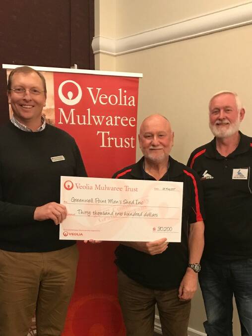 APPRECIATED: Trustee Justin Houghton delivers the donation to members of the Greenwell Point Men's Shed fundraising committee, Peter Taylor, shed president Bob Williamson and Grahame Ross (not pictured).

