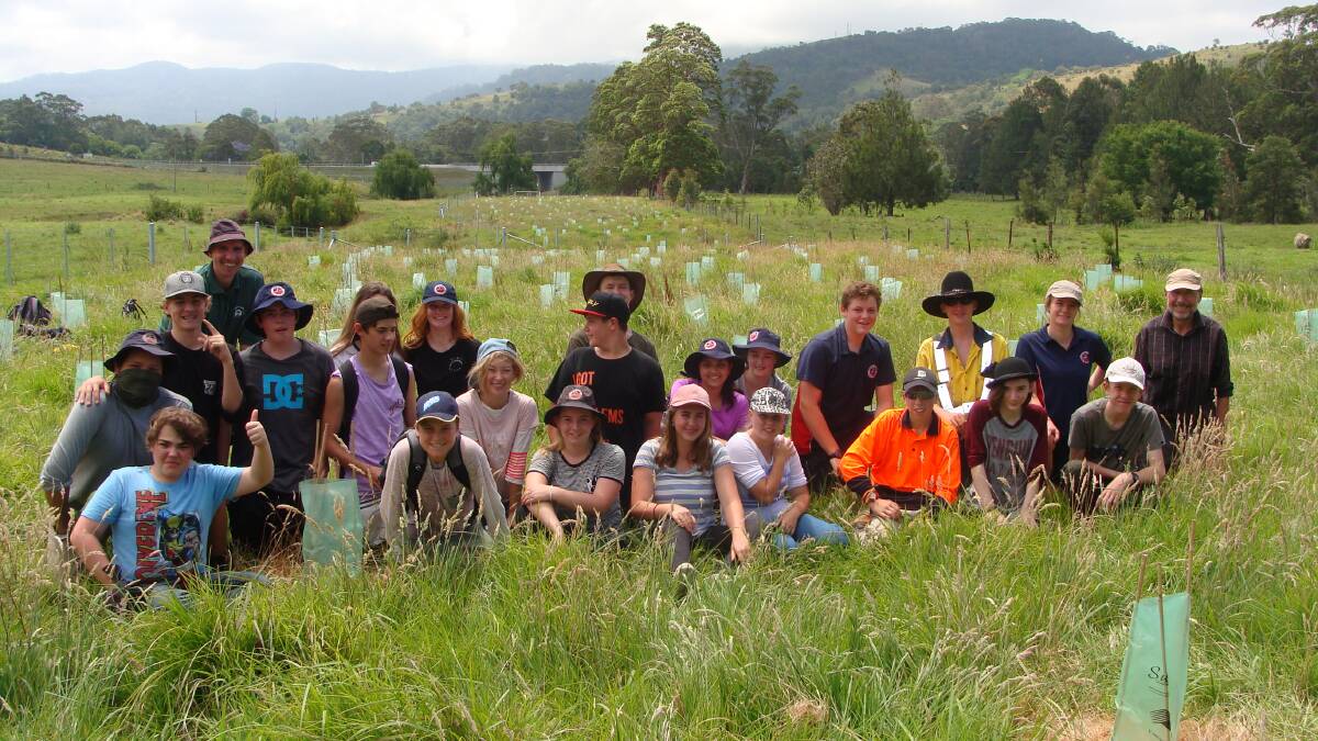 GREEN THUMB: Year nine students from Nowra Anglican College help replace some of the native plants lost to dry conditions in Berry. Photo contributed. 
