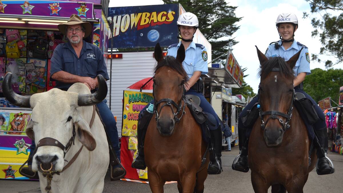 GUESS THE WEIGHT: Garry Nelson riding Charlie, Senior Constable Cherry and Constable Cunningham. A guessing competition at the Nowra Show saw Henry Suffolk, Namoi Bennett and Kylie Meehan all come withing a kilogram of guessing the combined weight of Charlie, Garry and the saddle-1026 kilograms.