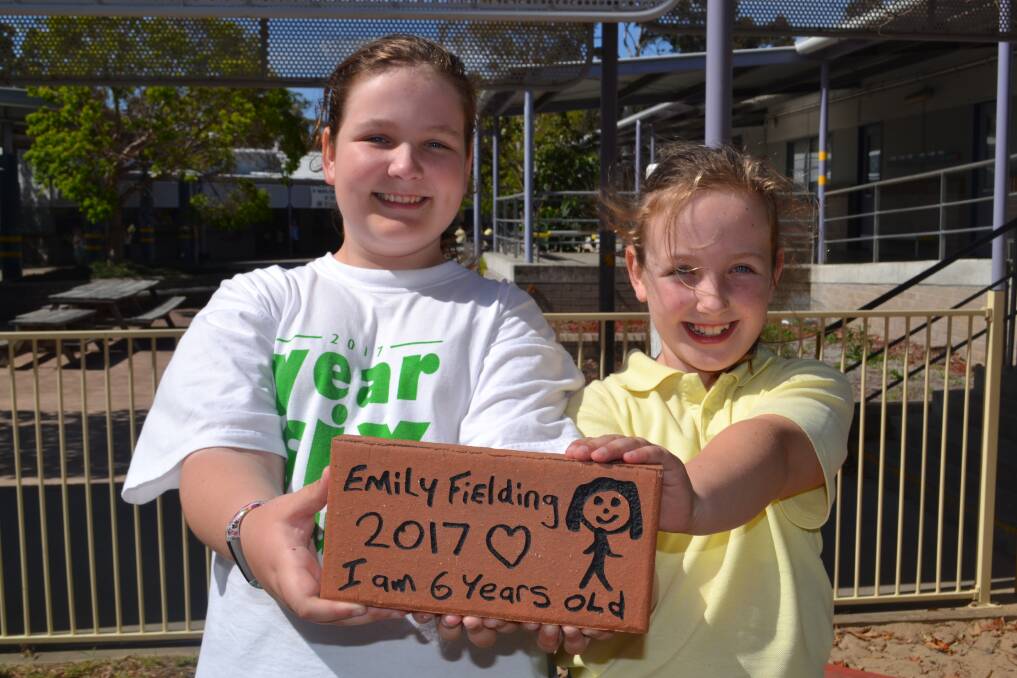 LONG LASTING: Brianna and Jorja Armstrong encourage everyone to buy a paver and leave their mark at Vincentia Public School forever. 