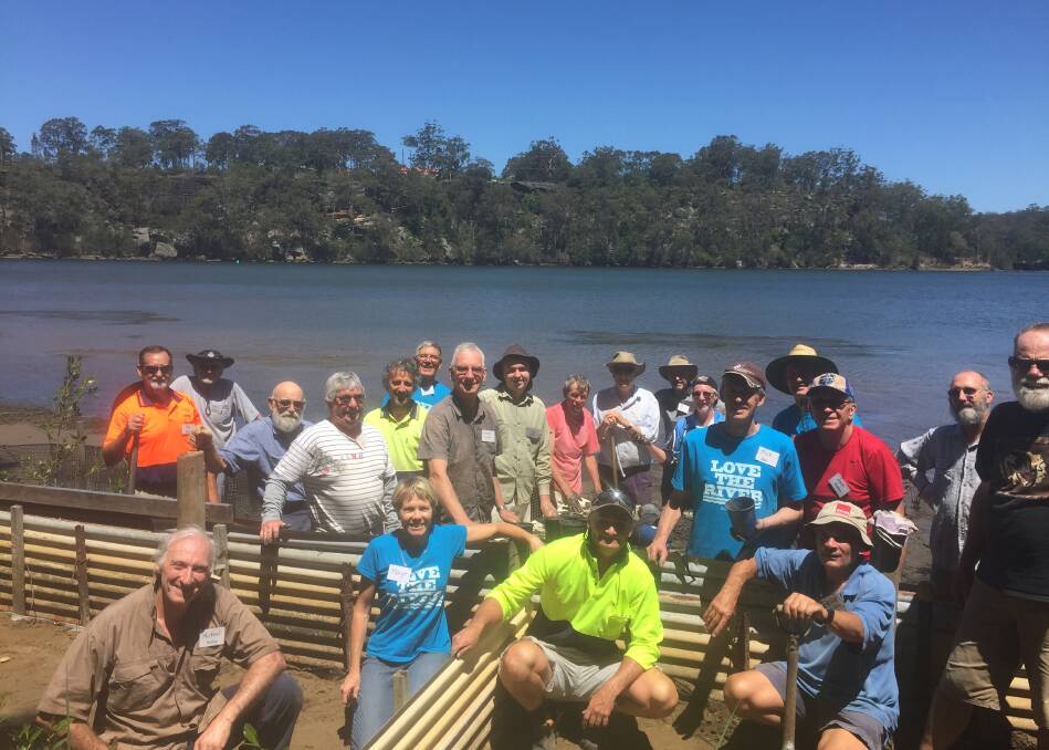 WELCOME, VOLUNTEERS: Shoalhaven Riverwatch take a quick moment out from their busy working bee. 
