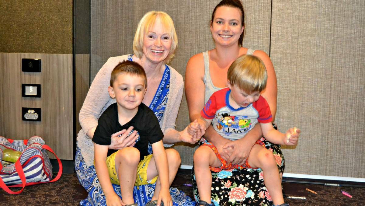 CHRISTMAS TREAT: Jack and Kohen Maybury from Basin View with Sue Schmidt from St Georges Basin and mum, Amy Schmidt at last year's Southern Cross Housing Christmas party. This year's event will be held at Parramatta Park.
