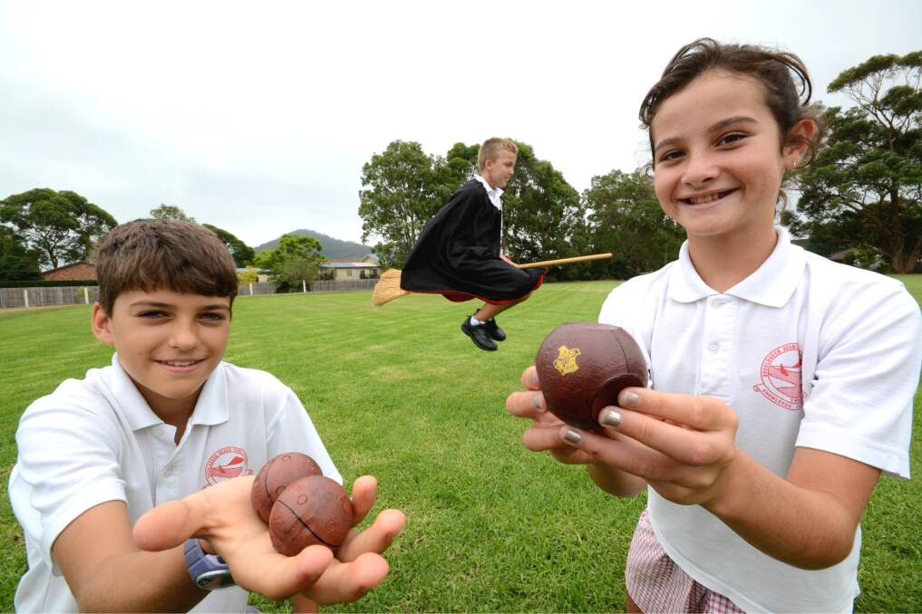 RECORD ATTEMPT: Shoalhaven Primary School students George Penn with Bludgers, ﻿Jack Klimcke on his version of the 'Nimbus 2000' and Ruby Marshall with the Quaffle in readiness for this month's attempt at a Guinness Book of Records Quidditch Match. Photo: Adam Wright. 
