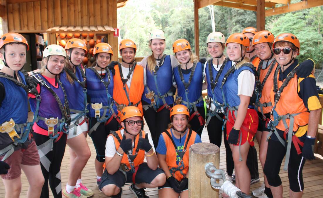 ACTION: Rotary exchange students from Denmark, Germany, Switzerland, Finland, Hungary, the Netherlands, Italy, Canada, and Brazil, with some thrill seeking Nowra Rotarians, prepare for their tree top rope adventure on the cliffs of the Shoalhaven River. Photo: contributed. 