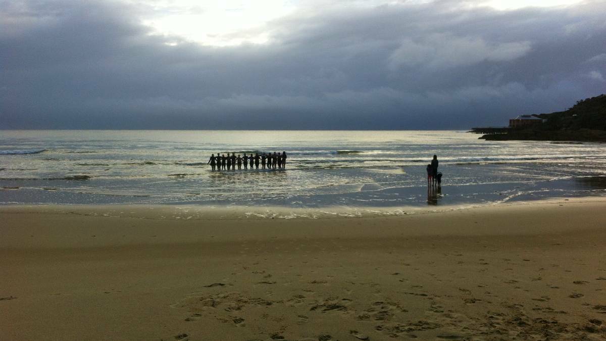 Morning swimmers at Tathra paid tribute to their lost friend, Chris Armstrong, by walking back into the water, arm in arm in April 2014.