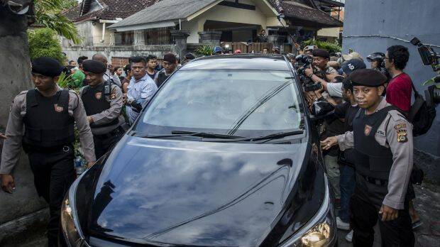 Indonesian police escort the car which Schapelle Corby is in as she prepares for deportation from Indonesia. Photo: Getty
