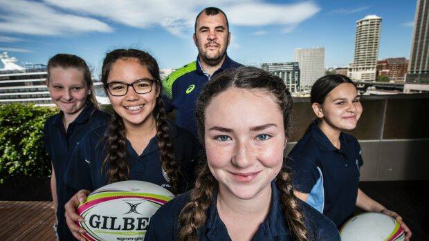 Wallabies coach Michael Cheika with girls from St Clare's High School, Emily Broquet-Mouledous, Kylie Gallagher, Niamh McGivney and Eliza Abdul. Photo: Jessica Hromas
