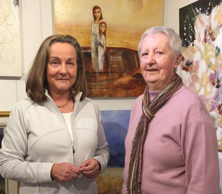 IMAGINATION: Vivien Tanner and Val McMahon in front of their respective artworks in the 51st Annual Shoalhaven Art Society exhibition at the Shoalhaven City Arts Centre.