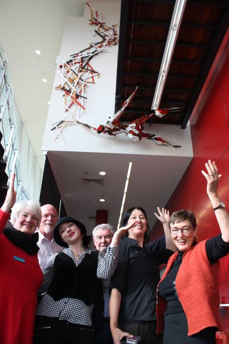 FIGURATIVE: Sculptor Elyssa Sykes-Smith (third from left) with members of the Arts Board and her recent installation at the Shoalhaven Entertainment Centre. 