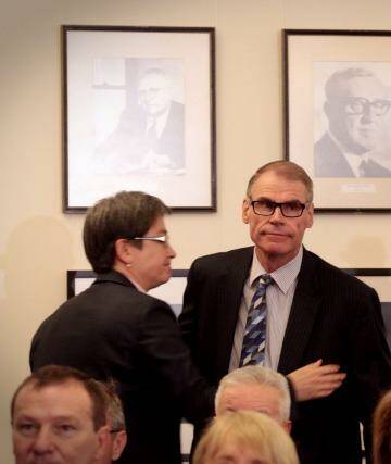 Senator John Faulkner is embraced by Senator Penny Wong beneath a portrait of former Prime Minister Gough Whitlam in the caucus room at Parliament House. Photo: Andrew Meares