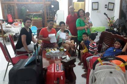 Lucky escape: Christianawati, her husband Ari Putro Cahyono and their extended family after missing flight QZ8501. Photo: Supplied