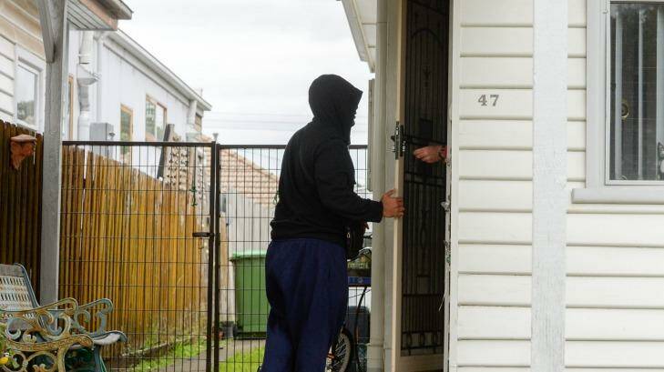 A man visits the Footscray house where Victoria's Joint Counter Terrorism Team was executing a search warrant on Tuesday. Photo: Justin McManus