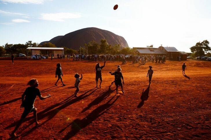 Children playing footy during the closing ceremony in the Mutitjulu community of the First Nations National Convention held in Uluru, on Friday 26 May 2017. fedpol Photo: Alex Ellinghausen