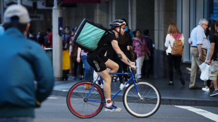 Sydney's city streets are not particularly bike friendly however Deliveroo and Foodora riders are becoming more common. Photo: James Brickwood