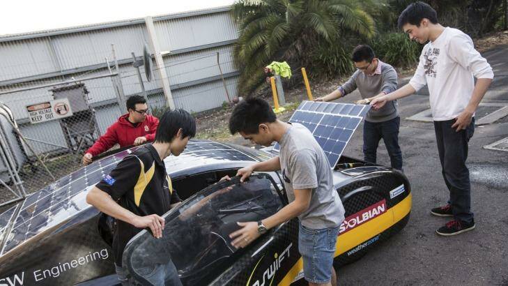 Record breaking: University of NSW students Kevin Moonyong Kim, Anthony Li, Gabriel Mendoza, Daniel Chen and James Sutanto prepare the Sunswift solar car. Photo: Dominic Lorrimer