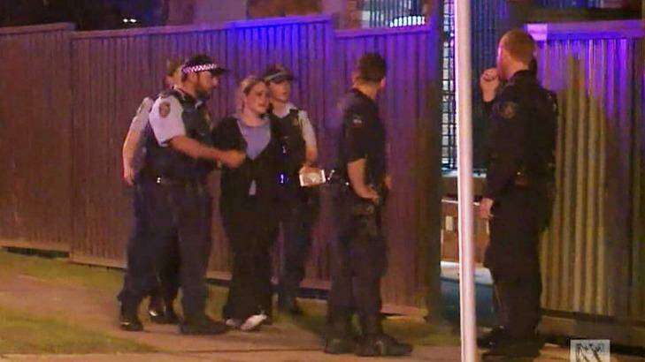Police console a woman at the scene of the crime on Brisbane Street. Photo: ABC News