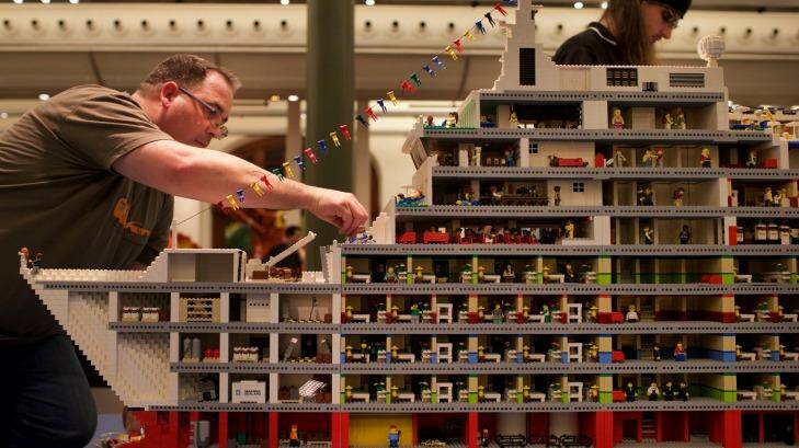 Ryan McNaught, left, with one of the displays in the Lego exhibition at the Town Hall.
 Photo: Wolter Peeters