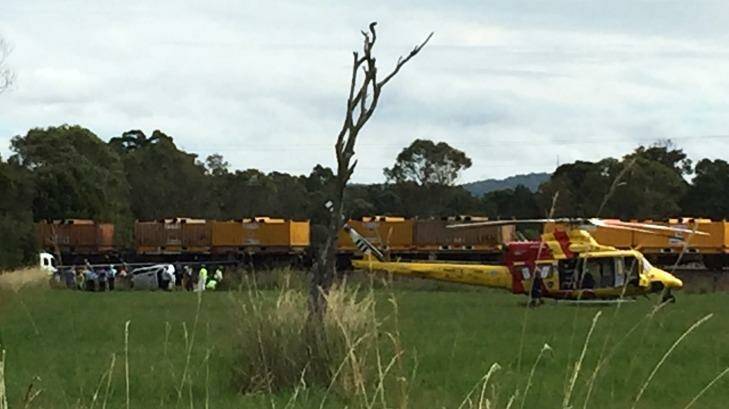 The Westpac Rescue Helicopter landed in a paddock beside the overturned vehicle. Photo: Lachlan Leeming
