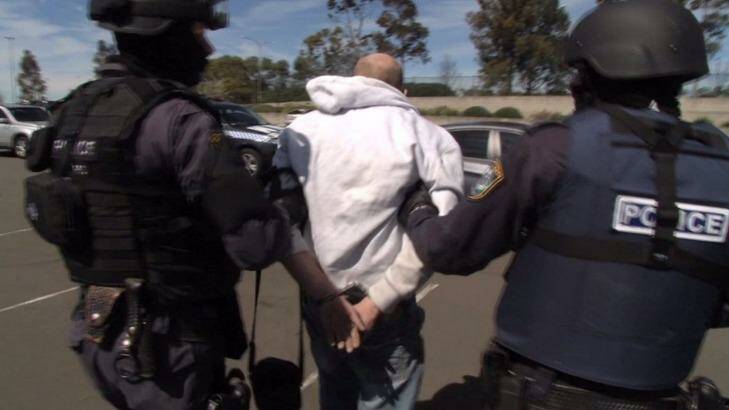 Busted: Police arrest a man in Sydney accused of making and supplying lethal pen guns. Photo: Police Media