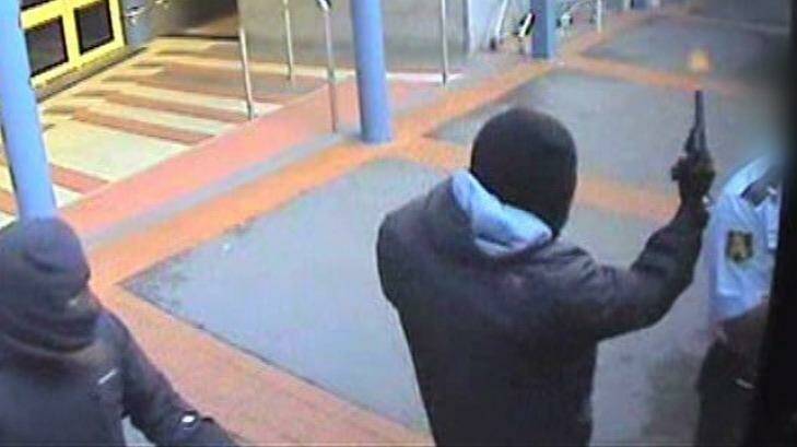 CCTV captures the moment an armed robber fires a gun next to a security guard during an attempted robbery of a cash-in-transit van near Broadway Shopping Centre in Glebe on March 4, 2013. Photo: Supplied