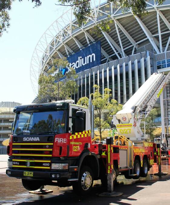 Firefighters perform a routine training exercise against a chemical or powder attack at ANZ Stadium on Thursday afternoon. Photo: Daniel Munoz