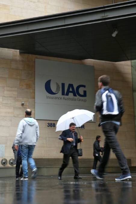 Pedestrians walk past the IAG House building, where the Insurance Australia Group Ltd. headquarters is located, in Sydney, Australia, on Wednesday, June 17, 2015. Warren Buffett's Berkshire Hathaway Inc. will pay A$500 million ($388 million) for a stake in IAG as part of a plan to expand in the region. Photographer: Brendon Thorne/Bloomberg