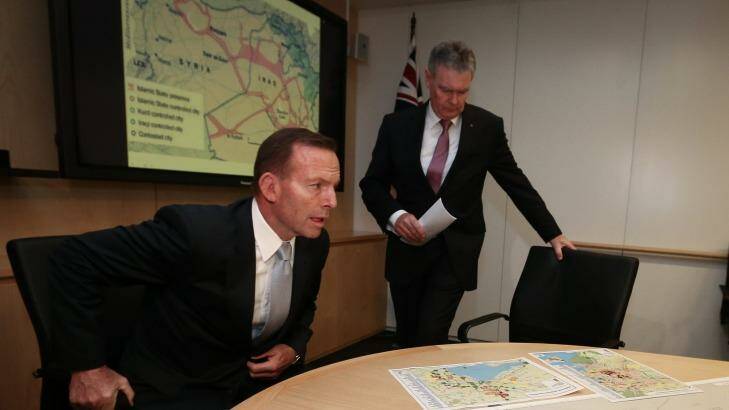 Prime Minister Tony Abbott and ASIO director-general Duncan Lewis with the maps during a briefing on Wednesday.  Photo: Alex Ellinghausen