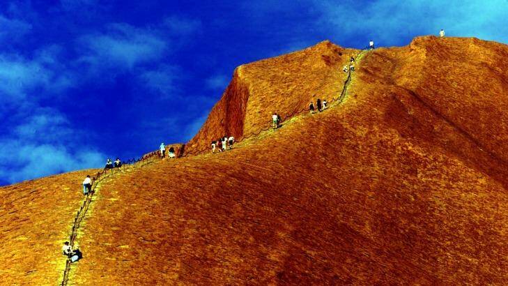 Climbers scale Uluru in the Northern Territory. Photo: Bryan Charlton