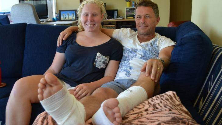 Rhianna Brown with her father Jeff at their Sanctuary Point home. Mr Brown was bitten by a shark on Monday morning. Photo: Jessica Long