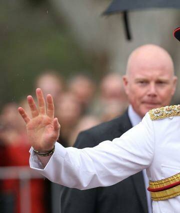 Prince Harry waves to members of the public outside the Australian War Memorial on Monday.  Photo: Stefan Postles