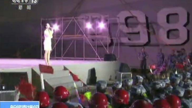 A singer performs for Chinese navy officers and construction workers on Fiery Cross Reef in the disputed South China Sea.  Photo: CCTV via AP
