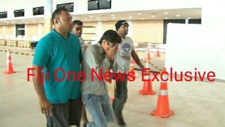 A Fijian media outlet has published pictures of Loghman Sawari being taken to the airport.