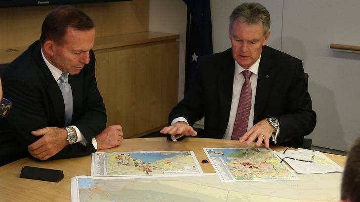 Prime Minister Tony Abbott and ASIO director-general Duncan Lewis look at the secret-but-not secret maps at ASIO Headquarters on Wednesday. Photo: Alex Ellinghausen