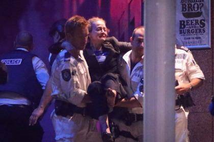 Marcia Mikhael is rescued from the Lindt cafe in Martin Place. Photo: Andrew Meares