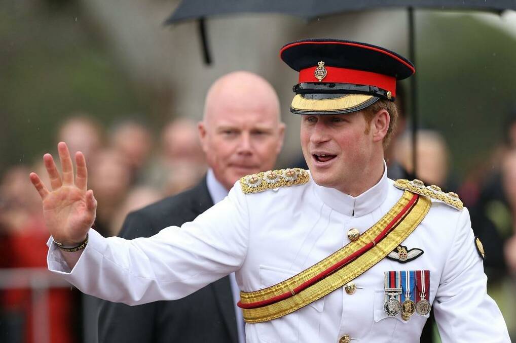 Prince Harry waves to members of the public outside the Australian War Memorial on Monday.  Photo: Stefan Postles