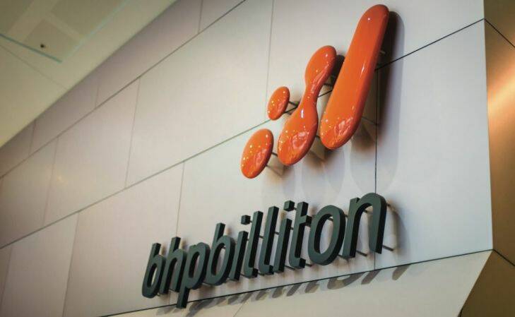 The BHP Billiton Ltd. logo is displayed at the company's headquarters in Melbourne, Australia, on Wednesday, Aug. 7, 2013. BHP, the world????????????s biggest mining company, signaled it will expand in the shale oil and gas industry in the U.S., forecasting global commodity demand will jump 75 percent over the next 15 years. Photographer: Ian Waldie/Bloomberg