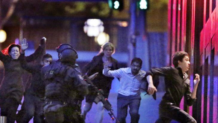 Hostages flee from the Lindt cafe in Martin Place during the early hours of December 16, 2014. Photo: Andrew Meares