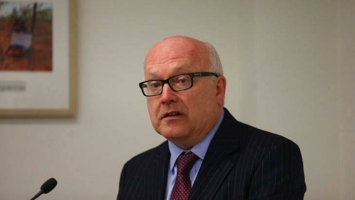 Federal Attorney-General George Brandis (pictured) and Social Services Minister Christian Porter said the federal government will work to develop a "national consistent approach" to a compensation scheme. Photo: Daniel Munoz