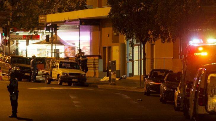 Police block off Charles Street in Parramatta, where witnesses saw two bodies lying on the ground. Photo: James Brickwood
