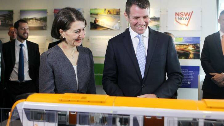 All aboard: Mike Baird and Gladys Berejiklian study a model of the new rolling stock at this week's announcement.  Photo: Natalie Roberts